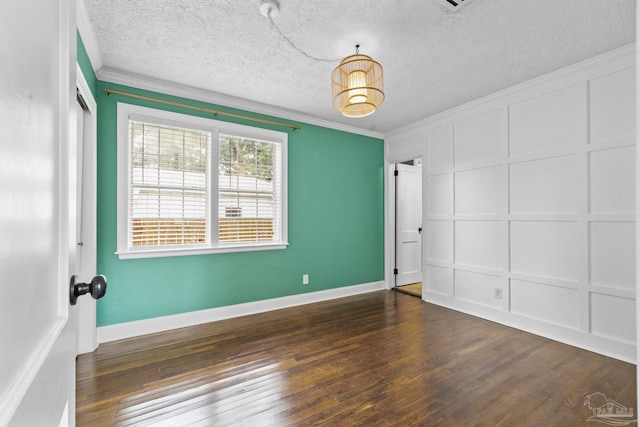 spare room with ornamental molding, a textured ceiling, and dark hardwood / wood-style flooring