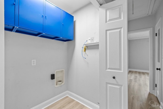 laundry area featuring washer hookup, cabinets, and light hardwood / wood-style floors