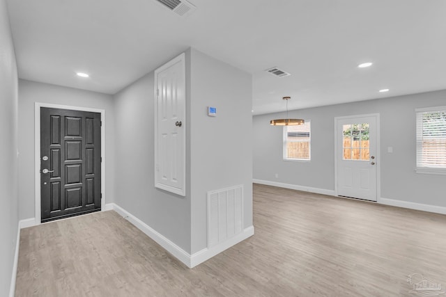 entryway featuring light wood-type flooring, baseboards, and visible vents