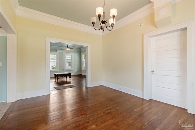 unfurnished dining area featuring crown molding, dark hardwood / wood-style flooring, and ceiling fan with notable chandelier