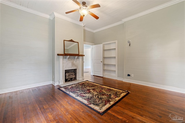 living room featuring a high end fireplace, dark wood-type flooring, and ornamental molding