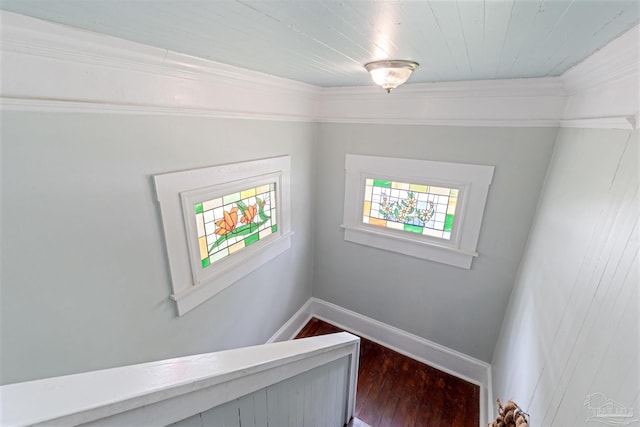 stairs with hardwood / wood-style floors and crown molding