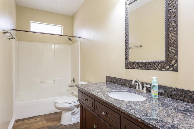 full bathroom featuring vanity, hardwood / wood-style floors,  shower combination, and toilet