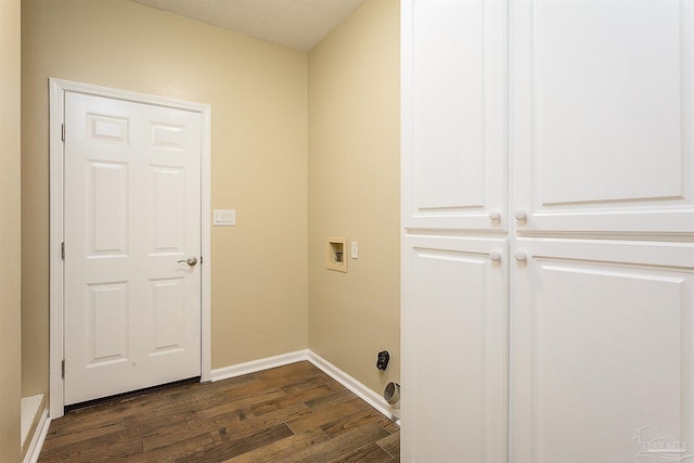 washroom with dark hardwood / wood-style floors, washer hookup, and a textured ceiling