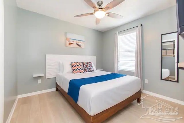 bedroom with light hardwood / wood-style flooring and ceiling fan