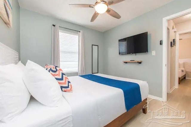 bedroom with hardwood / wood-style flooring and ceiling fan