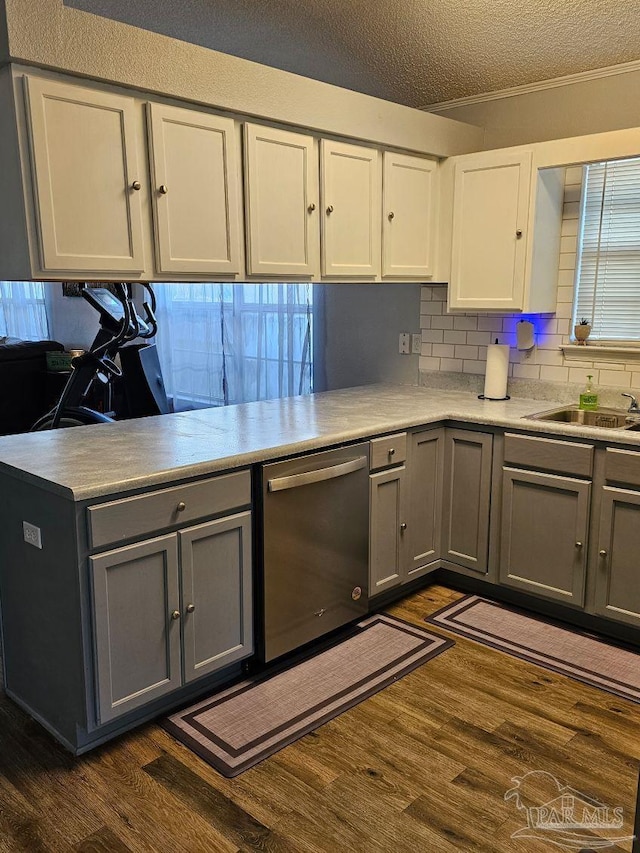 kitchen with dishwasher, gray cabinetry, a textured ceiling, and dark hardwood / wood-style floors