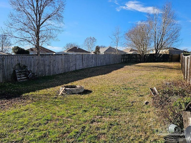 view of yard with a fire pit