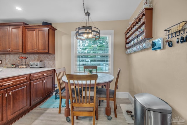 dining room featuring a notable chandelier and light wood-type flooring