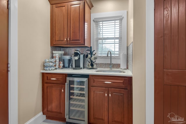 bar featuring wine cooler, sink, and backsplash