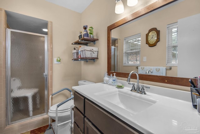 bathroom with vanity, toilet, and a shower with door