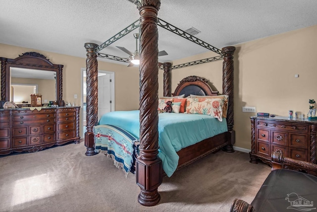 carpeted bedroom featuring ceiling fan and a textured ceiling