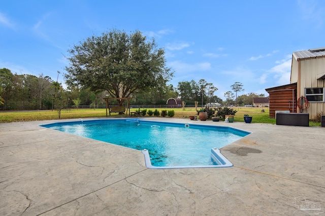 view of swimming pool featuring a patio area and a lawn