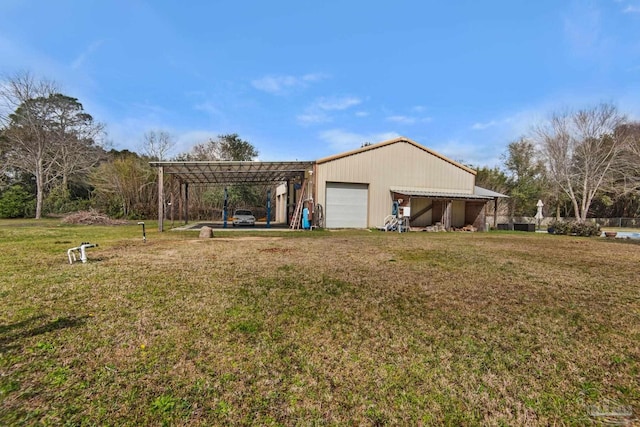 exterior space with a carport, a garage, and a yard