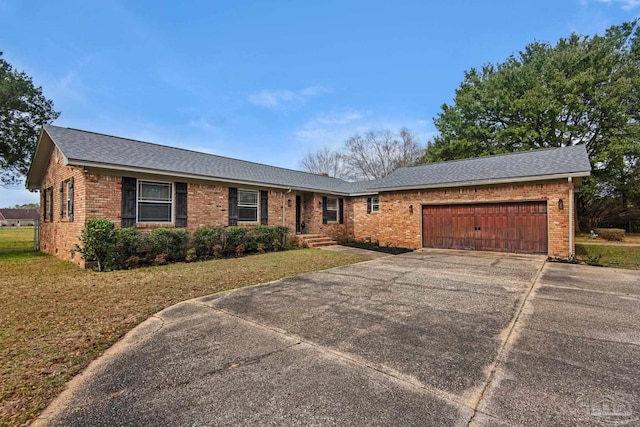 ranch-style house with a garage and a front lawn