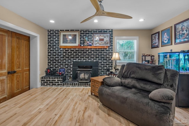 living room with hardwood / wood-style flooring and ceiling fan