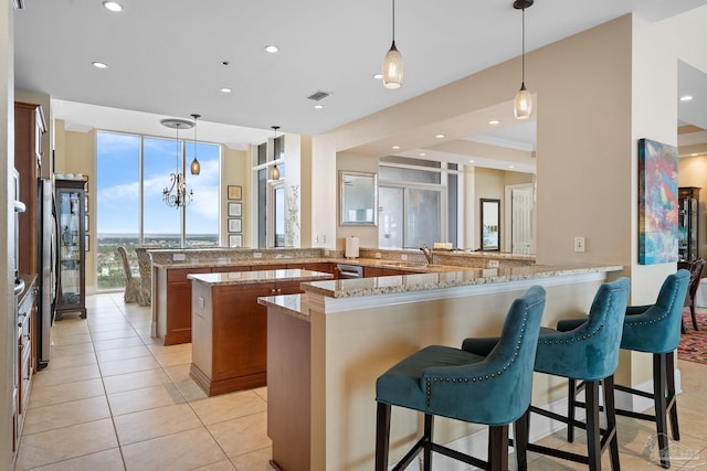 kitchen with kitchen peninsula, pendant lighting, and a breakfast bar