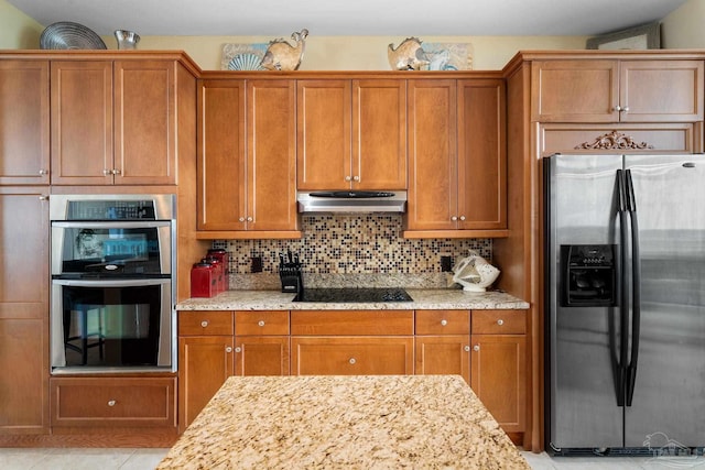 kitchen with tasteful backsplash, light stone counters, light tile patterned floors, and stainless steel appliances