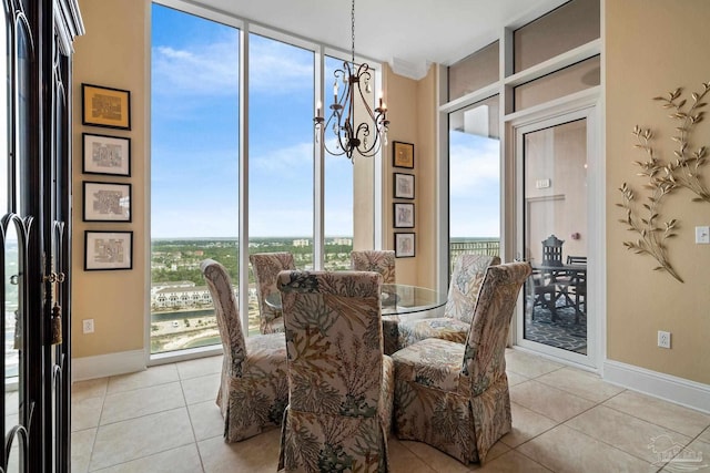 dining area with plenty of natural light, light tile patterned flooring, and a chandelier