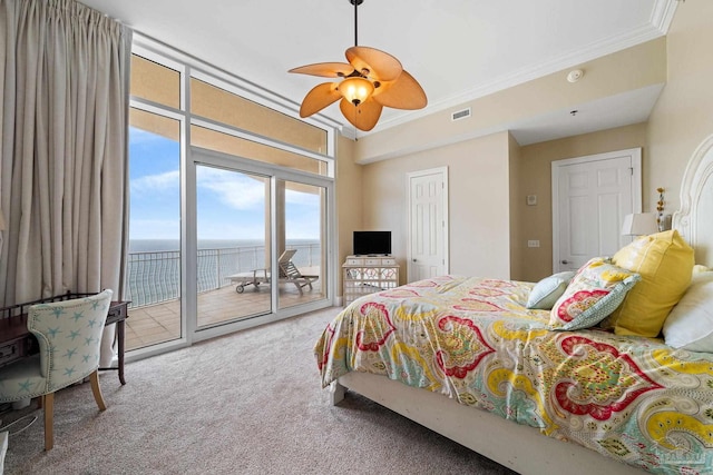 bedroom featuring access to outside, crown molding, carpet flooring, ceiling fan, and a closet