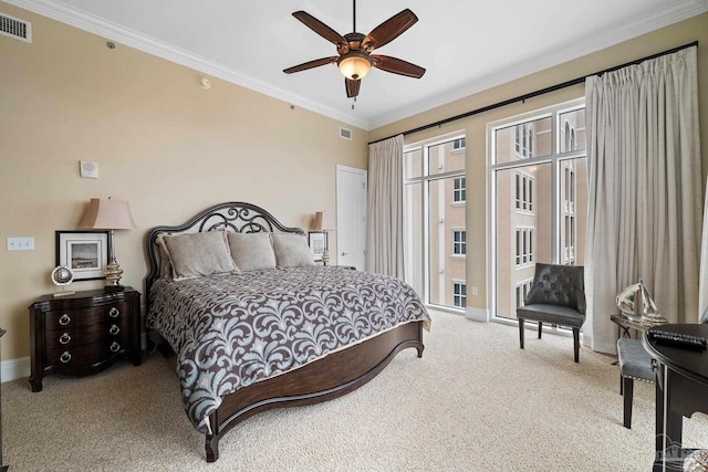 carpeted bedroom with ceiling fan and ornamental molding