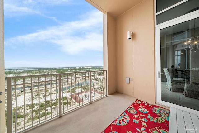 balcony with a water view and a beach view