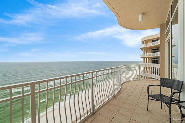 balcony with a beach view and a water view