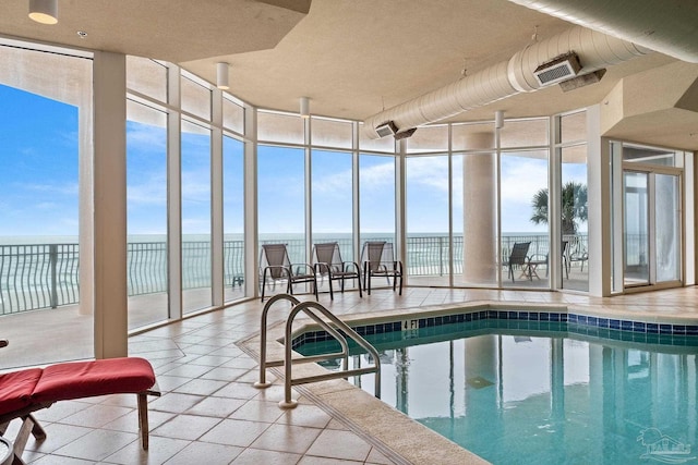 view of swimming pool with a water view