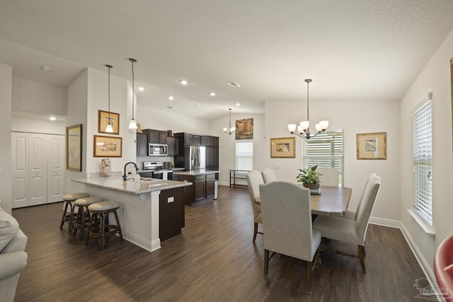 6319 Red Pepper Dr, Gulf Breeze, FL 32563 - dining space with lofted ceiling, a chandelier, dark wood-style flooring, plenty of natural light, and recessed lighting