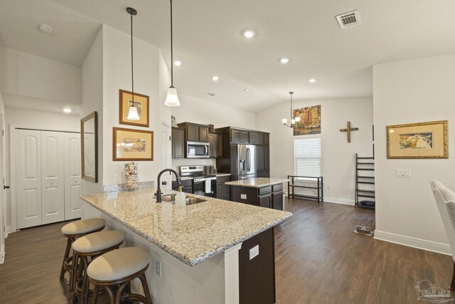 6319 Red Pepper Dr, Gulf Breeze, FL 32563 - kitchen with appliances with stainless steel finishes, a sink, vaulted ceiling, a center island, and baseboards