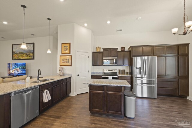 6319 Red Pepper Dr, Gulf Breeze, FL 32563 - kitchen featuring stainless steel appliances, a sink, a peninsula, dark brown cabinetry, and dark wood-style floors