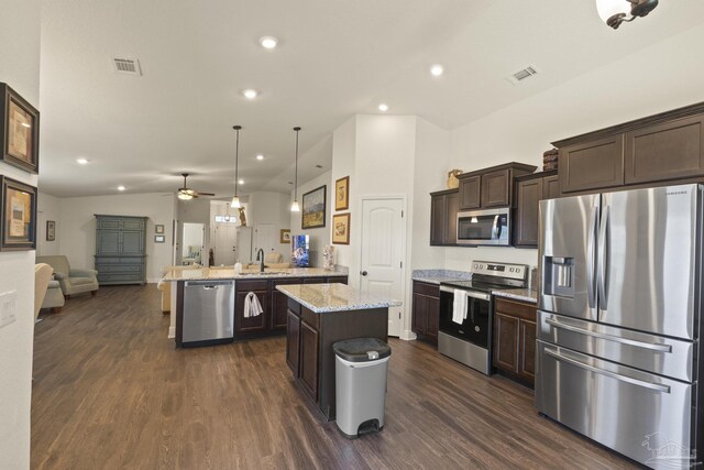6319 Red Pepper Dr, Gulf Breeze, FL 32563 - kitchen featuring appliances with stainless steel finishes, open floor plan, a peninsula, dark brown cabinets, and dark wood-style flooring