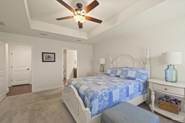 6319 Red Pepper Dr, Gulf Breeze, FL 32563 - bedroom featuring a tray ceiling, carpet, baseboards, ensuite bathroom, and ceiling fan