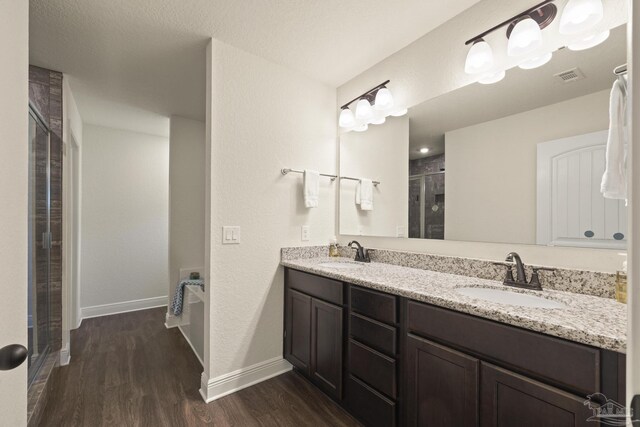 6319 Red Pepper Dr, Gulf Breeze, FL 32563 - full bathroom with wood finished floors, a stall shower, double vanity, and baseboards