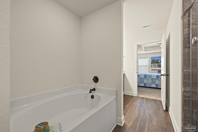 6319 Red Pepper Dr, Gulf Breeze, FL 32563 - ensuite bathroom with wood finished floors, a bath, and baseboards
