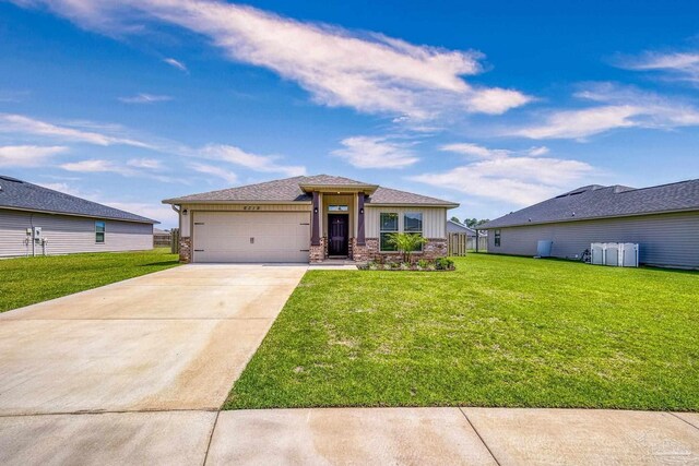 6319 Red Pepper Dr, Gulf Breeze, FL 32563 - prairie-style home featuring a garage, concrete driveway, a front lawn, and board and batten siding