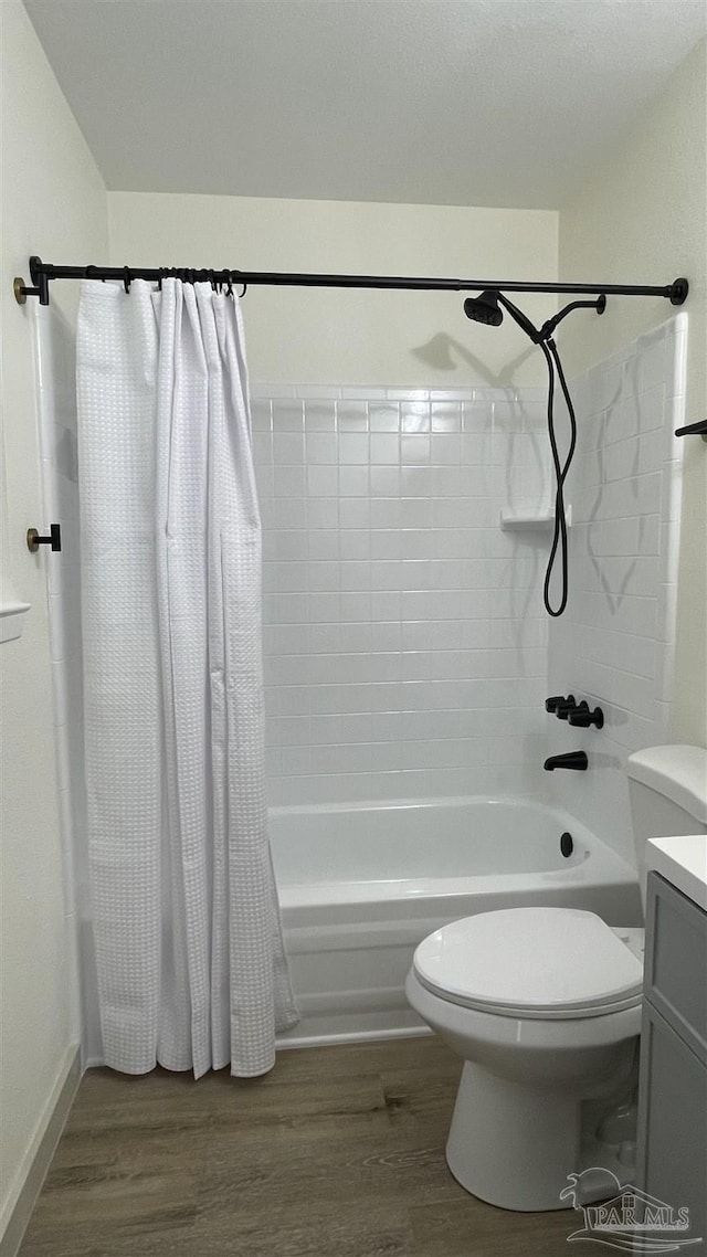 full bathroom with toilet, shower / bath combination with curtain, hardwood / wood-style flooring, and vanity