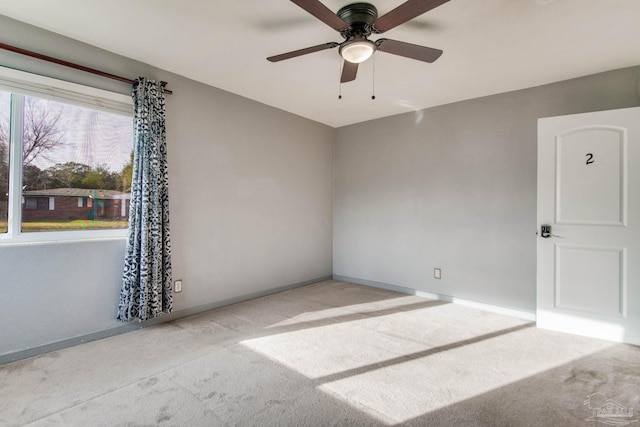 carpeted empty room with ceiling fan