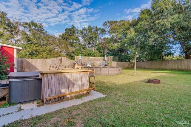 view of yard with a pool with hot tub