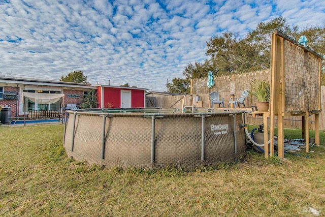 exterior space featuring a lawn and a fenced in pool