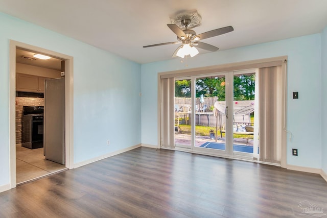 spare room featuring ceiling fan and wood-type flooring