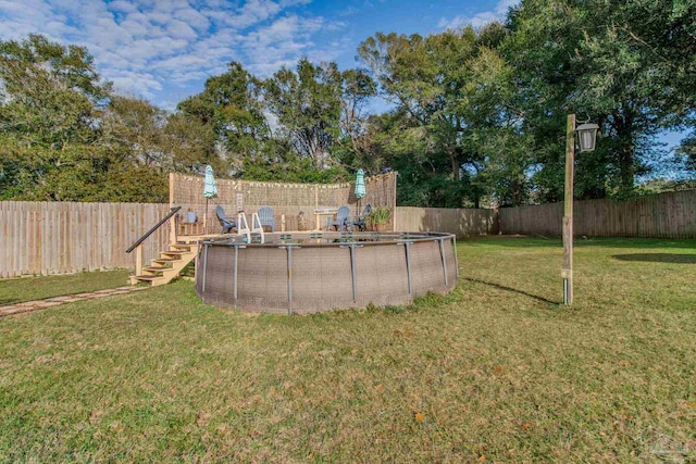 view of yard with a fenced in pool