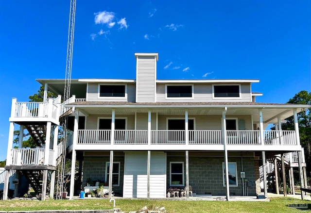 rear view of property featuring a yard