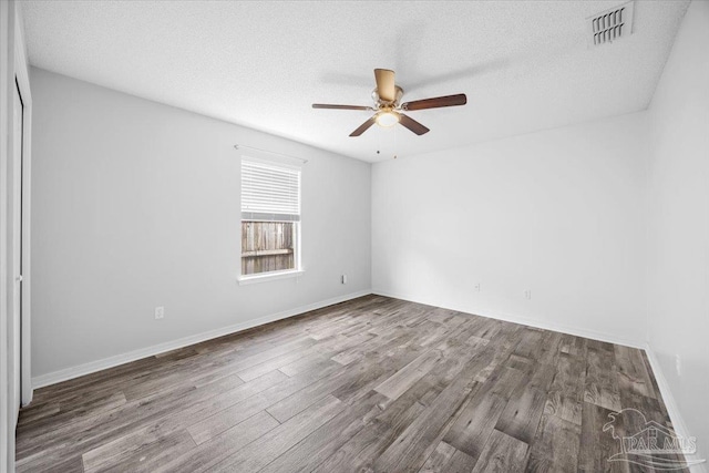 spare room featuring hardwood / wood-style floors, a textured ceiling, and ceiling fan