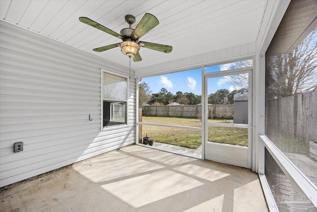 unfurnished sunroom with ceiling fan