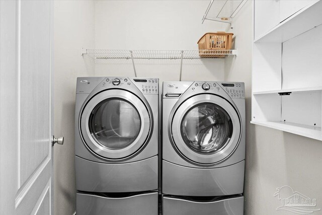 clothes washing area featuring washer and dryer