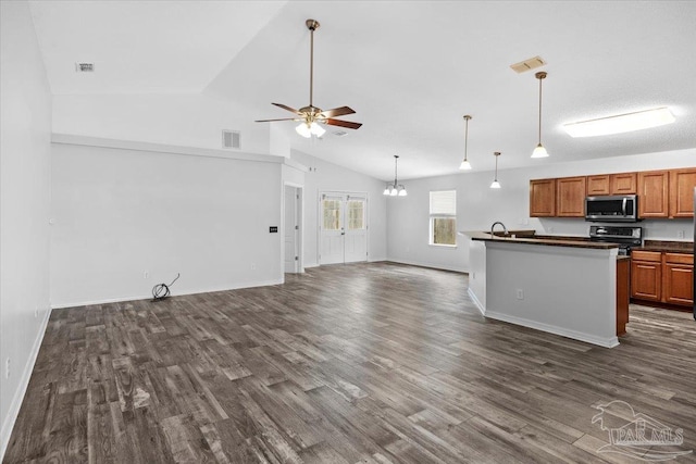 kitchen with lofted ceiling, sink, stainless steel appliances, dark hardwood / wood-style flooring, and ceiling fan with notable chandelier