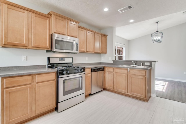 kitchen with light brown cabinetry, visible vents, stainless steel appliances, and a sink