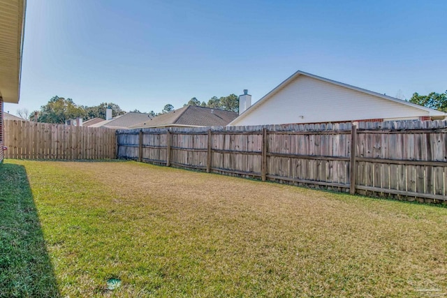 view of yard with a fenced backyard