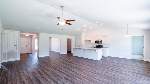 unfurnished living room featuring dark wood-type flooring, ceiling fan, lofted ceiling, and sink